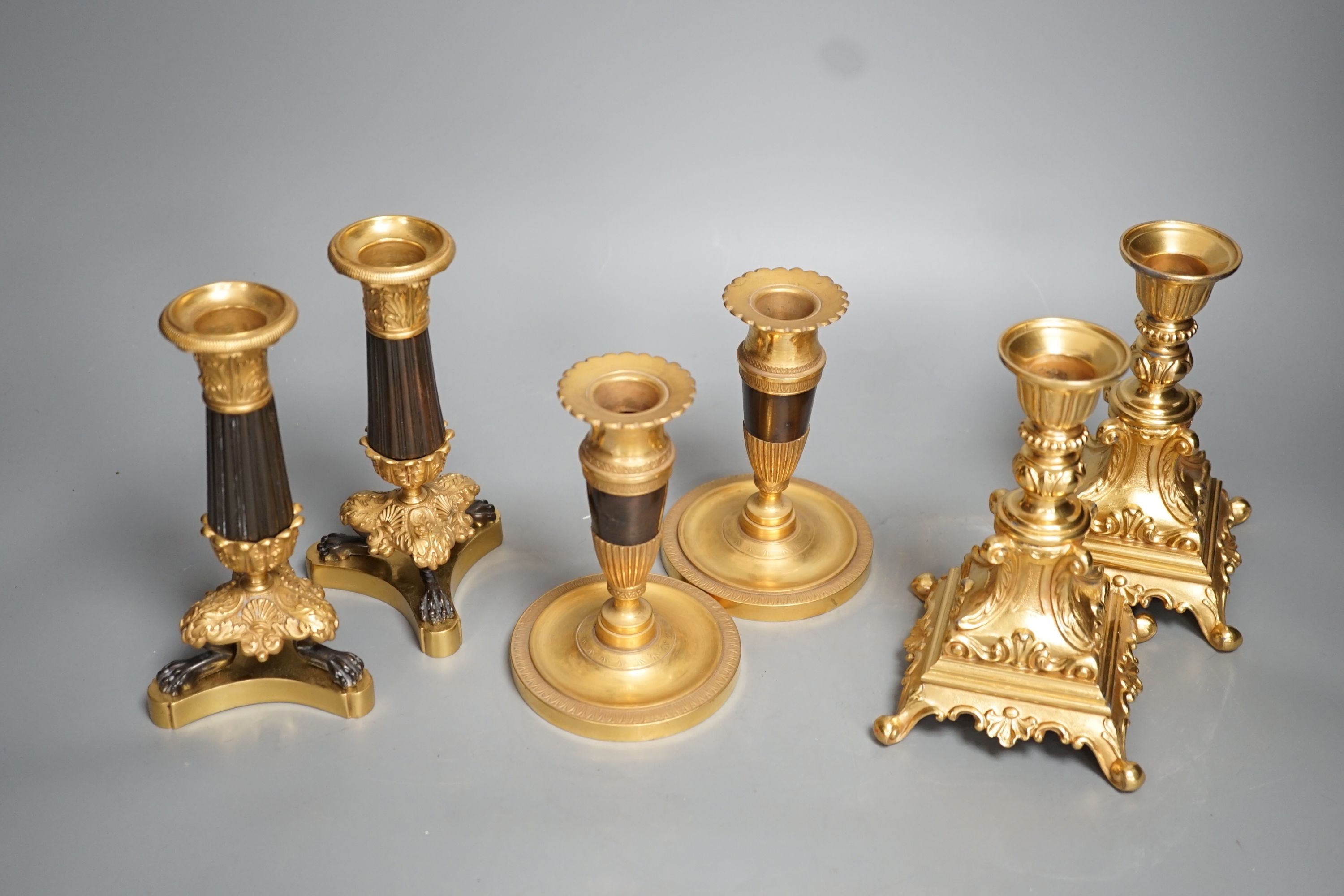 Three pairs of gilt metal candlesticks, tallest 16cm